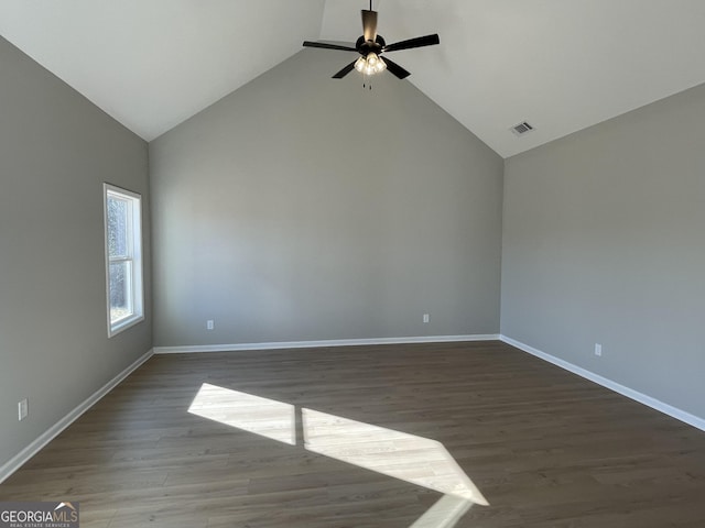 empty room featuring wood finished floors, visible vents, and baseboards