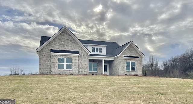 craftsman inspired home with brick siding and a front yard