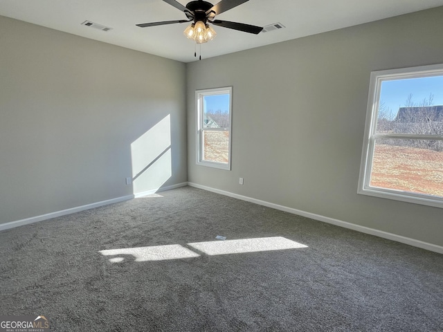 empty room with carpet, baseboards, and visible vents