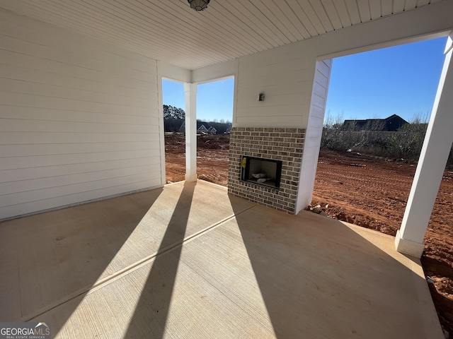 view of patio / terrace featuring an outdoor brick fireplace