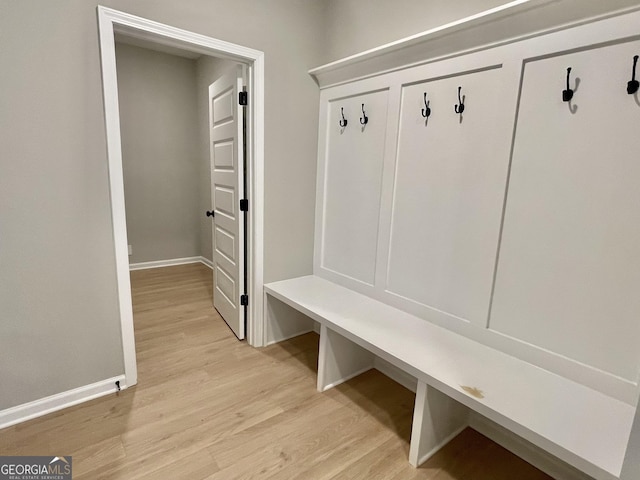 mudroom with light wood-style floors and baseboards