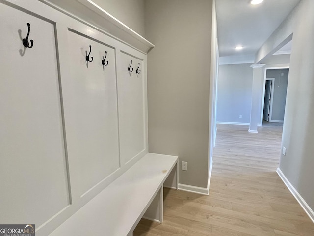 mudroom with light wood-style floors and baseboards