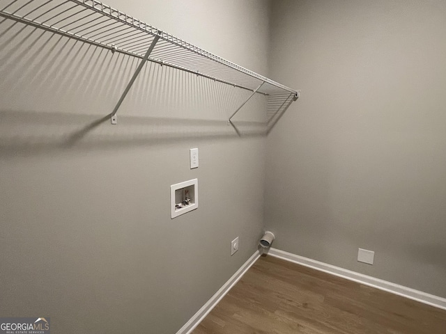 laundry area featuring laundry area, baseboards, washer hookup, and dark wood-style flooring