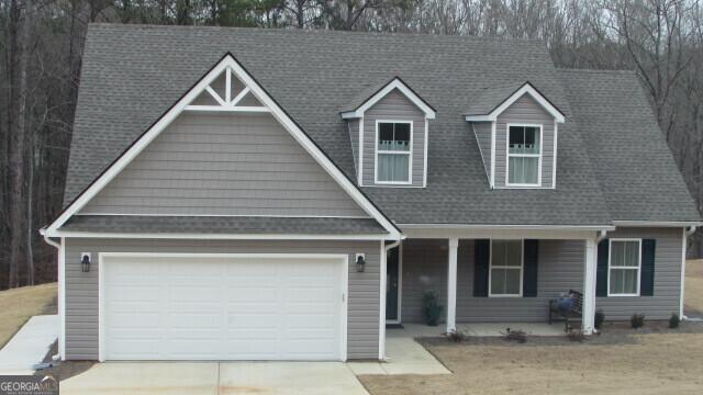 view of front of home featuring covered porch and a garage