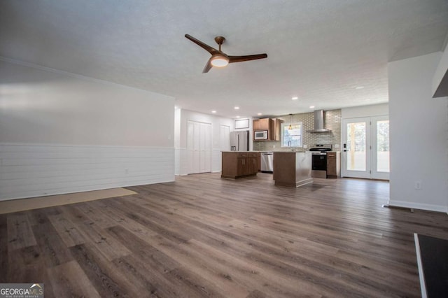 unfurnished living room with ceiling fan, dark wood-type flooring, and sink