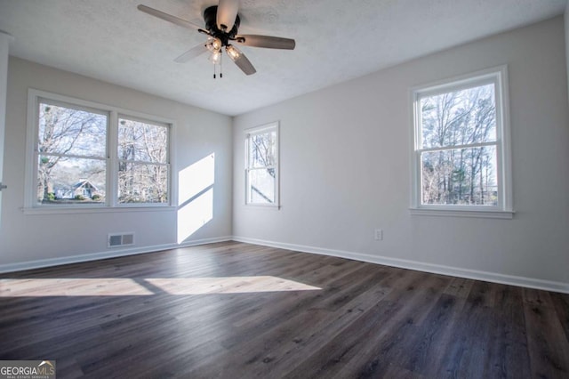 unfurnished room with ceiling fan and dark wood-type flooring