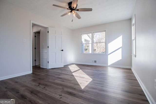 spare room featuring dark hardwood / wood-style floors and ceiling fan