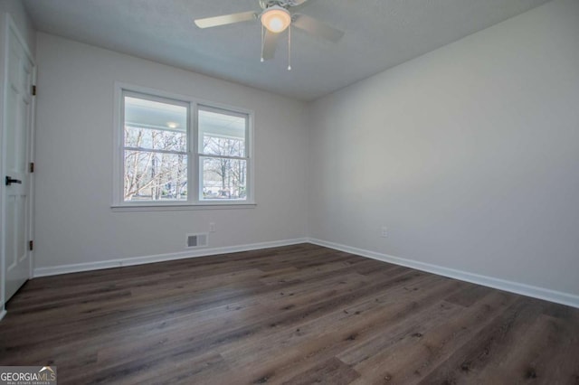 unfurnished room with dark hardwood / wood-style floors and ceiling fan