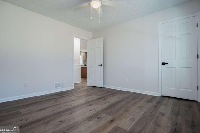 unfurnished bedroom with ceiling fan and dark hardwood / wood-style floors