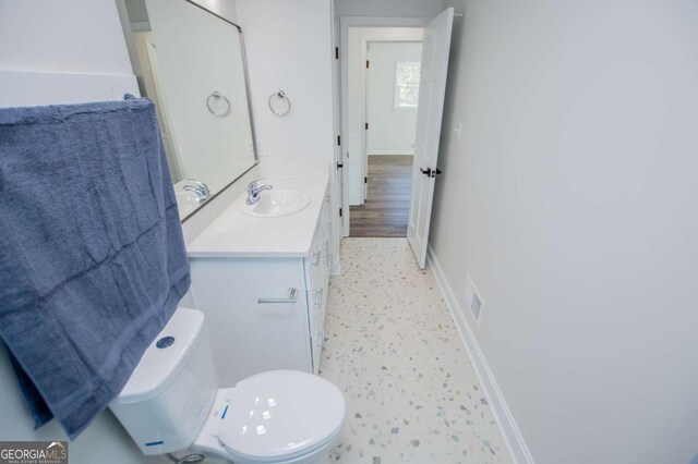 bathroom featuring vanity and toilet