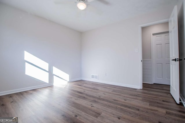 unfurnished room featuring ceiling fan and dark wood-type flooring