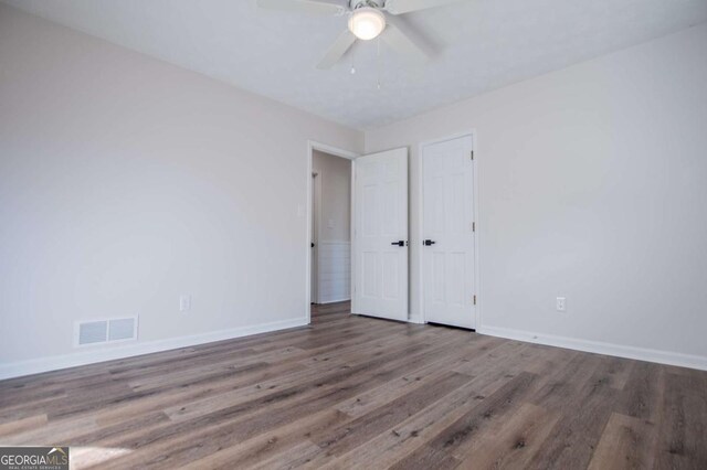 empty room featuring ceiling fan and hardwood / wood-style flooring