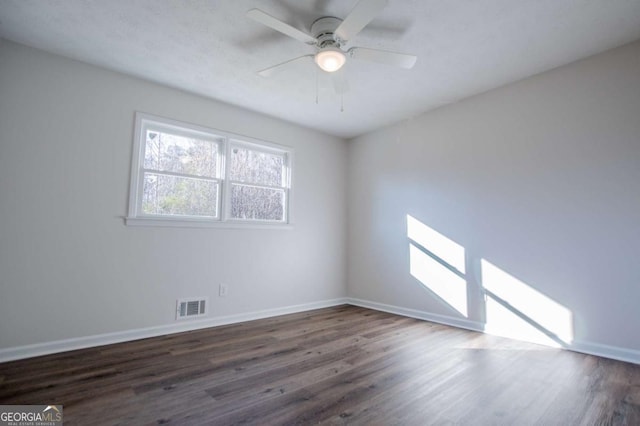 spare room featuring ceiling fan and dark hardwood / wood-style flooring