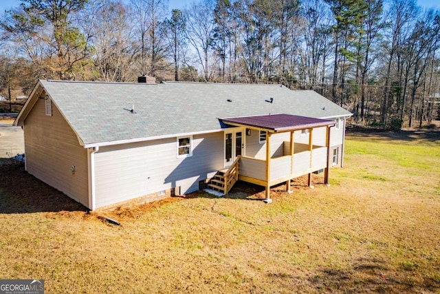 back of house featuring a yard