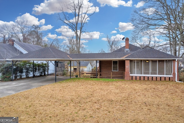 view of front of property featuring a sunroom and a carport