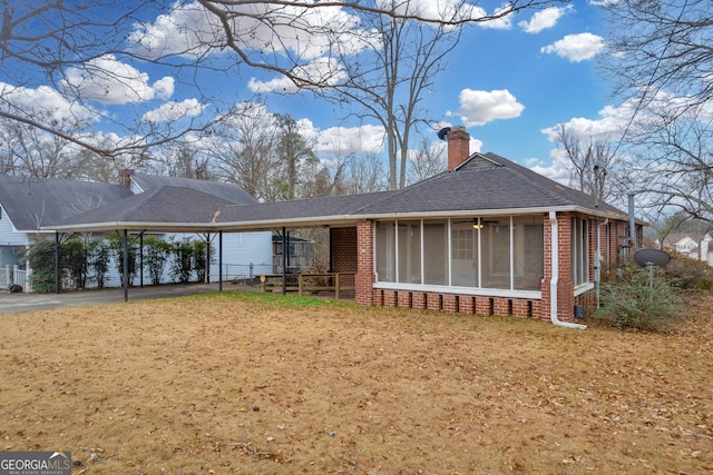 view of front of home featuring a carport and a sunroom