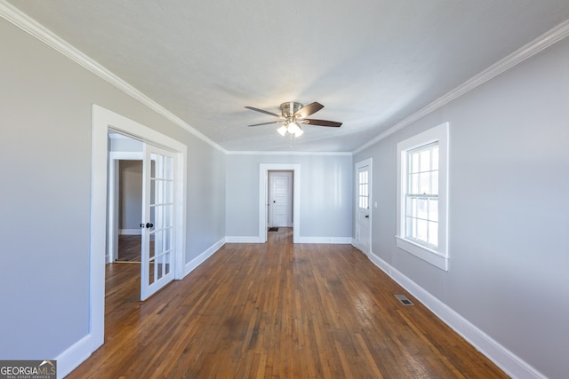 unfurnished room featuring baseboards, dark wood finished floors, crown molding, and french doors