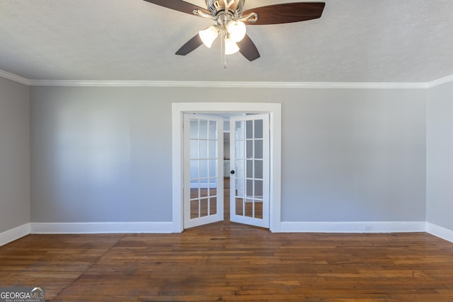 spare room featuring baseboards, wood-type flooring, ceiling fan, ornamental molding, and a textured ceiling