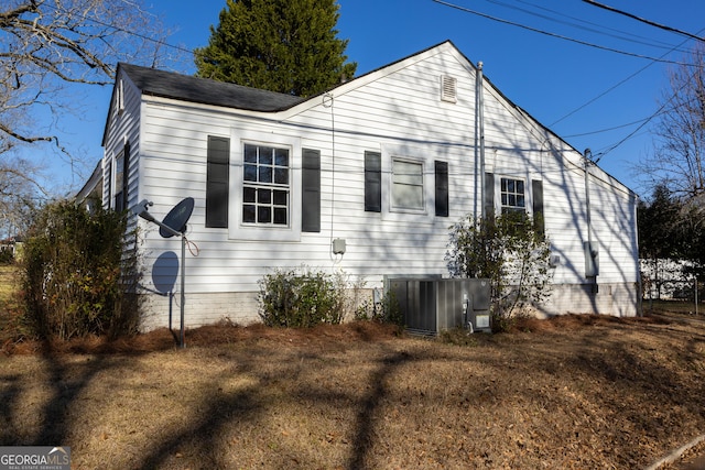 view of side of home with central AC unit