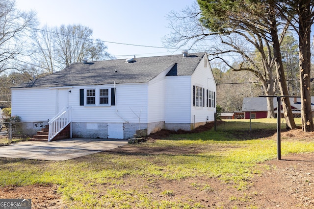 rear view of property with crawl space, fence, a lawn, and a patio