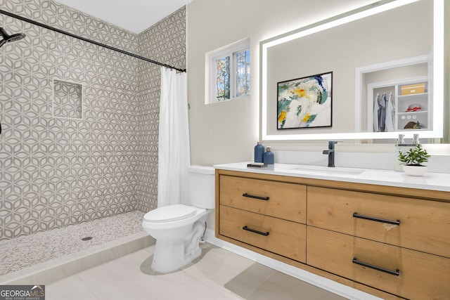 bathroom with a shower with curtain, vanity, toilet, and tile patterned flooring