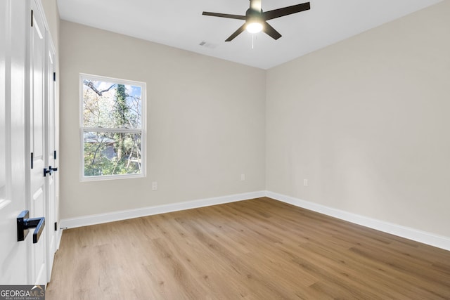 spare room featuring light hardwood / wood-style floors and ceiling fan