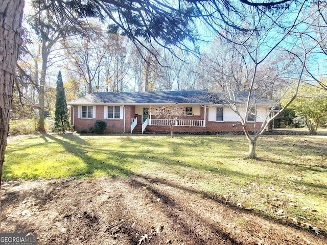 ranch-style house featuring crawl space, covered porch, brick siding, and a front lawn