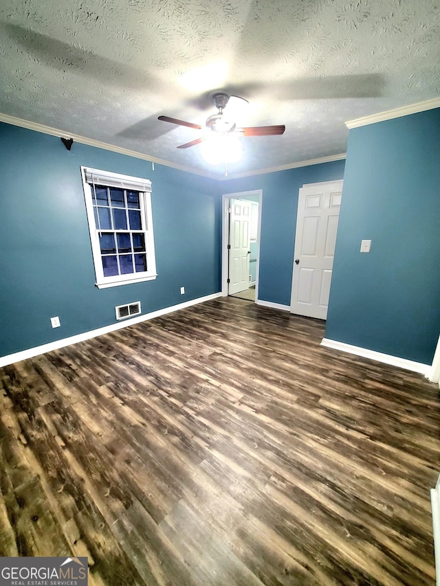 unfurnished room featuring ornamental molding, ceiling fan, baseboards, and wood finished floors