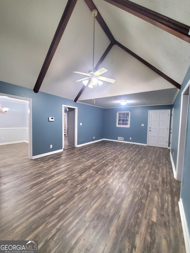 unfurnished living room featuring a ceiling fan, beamed ceiling, baseboards, and wood finished floors