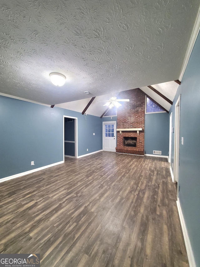 unfurnished living room featuring lofted ceiling, a brick fireplace, visible vents, and wood finished floors