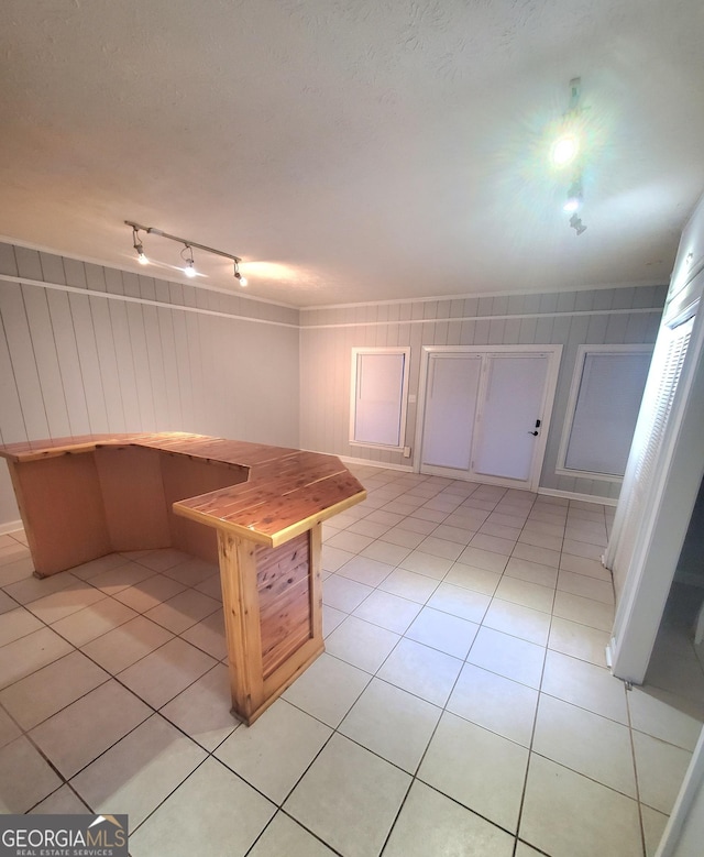 kitchen with rail lighting and light tile patterned floors