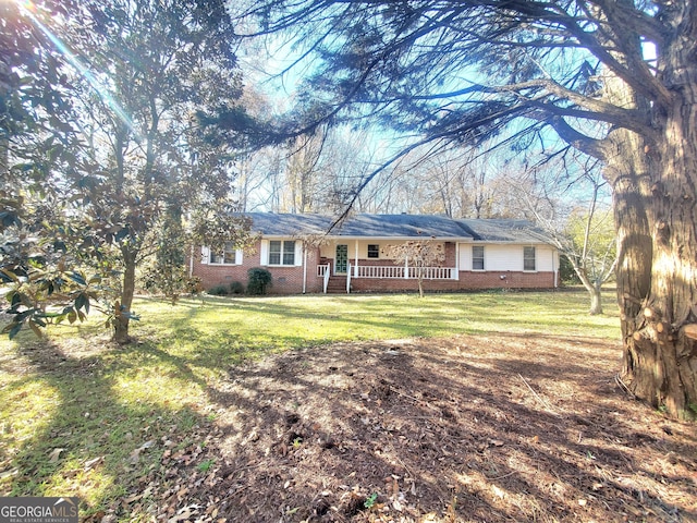 single story home featuring covered porch and a front lawn