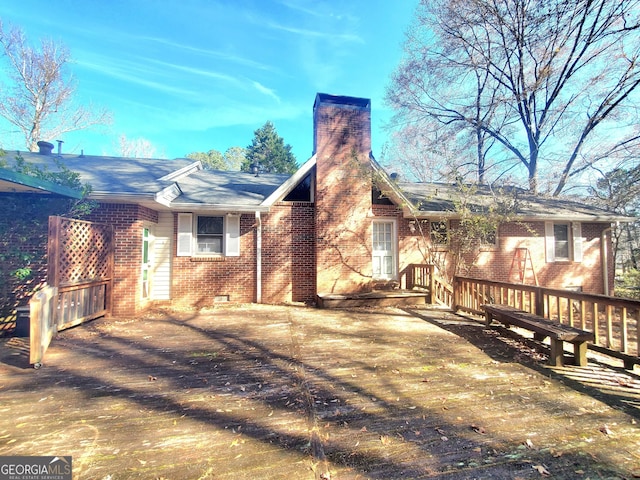 back of house featuring crawl space, a chimney, and brick siding