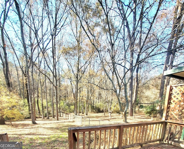 wooden terrace with a wooded view