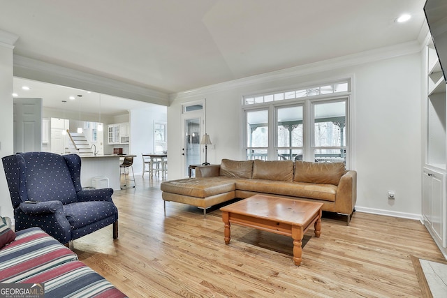 living room with light hardwood / wood-style floors and ornamental molding