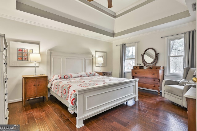 bedroom featuring ceiling fan, dark hardwood / wood-style floors, a raised ceiling, and crown molding