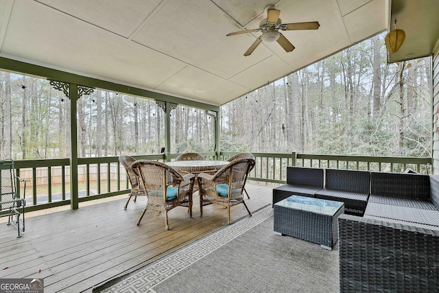 sunroom / solarium featuring ceiling fan