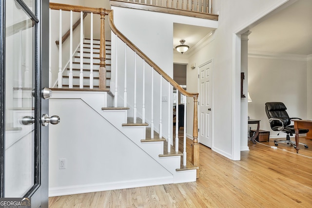 entryway featuring light hardwood / wood-style flooring and crown molding