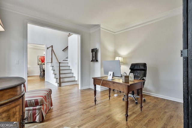 office area with light wood-type flooring and crown molding