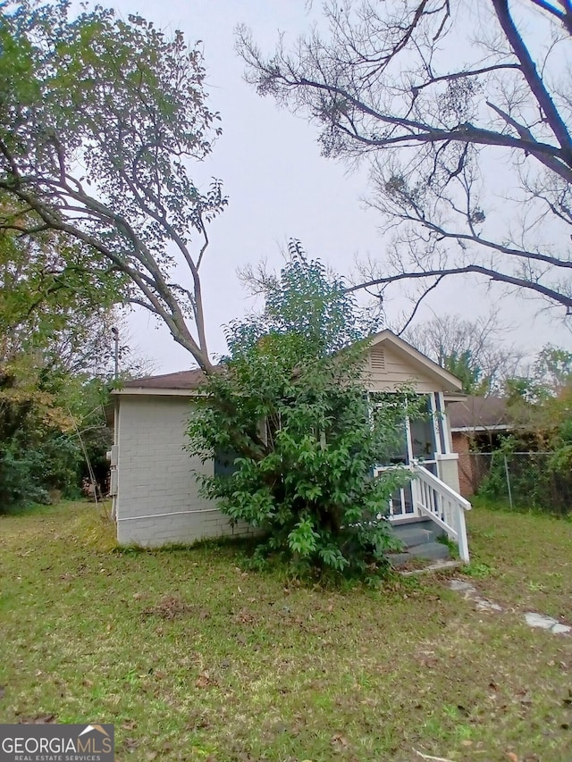 rear view of property with a yard