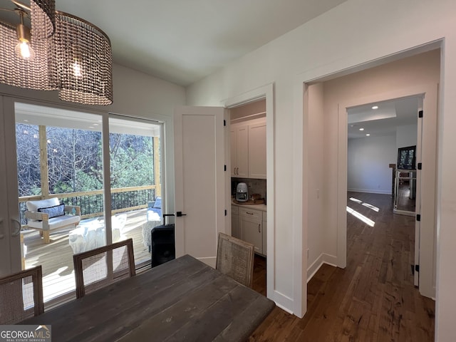 interior space featuring dark hardwood / wood-style floors and vaulted ceiling