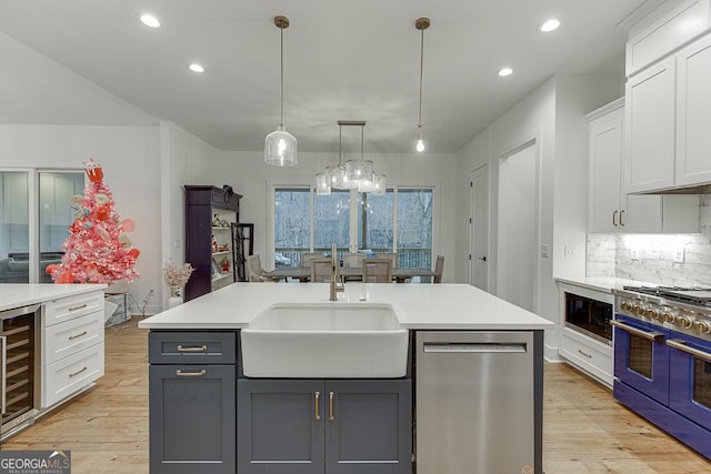 kitchen featuring white cabinetry, a kitchen island with sink, and stainless steel appliances