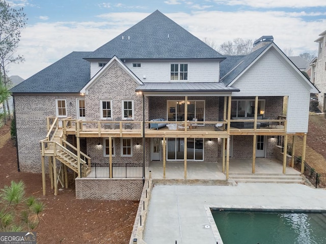 rear view of property with a pool side deck and a patio area