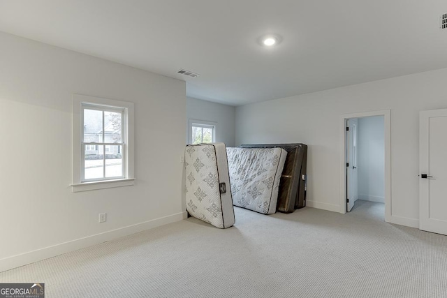 unfurnished bedroom featuring light carpet