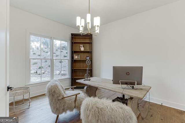 office area with hardwood / wood-style flooring and an inviting chandelier