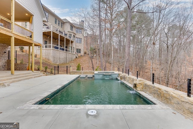 view of pool with pool water feature, an in ground hot tub, and a patio