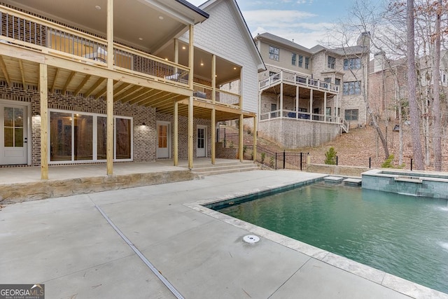 view of pool with an in ground hot tub and a patio area