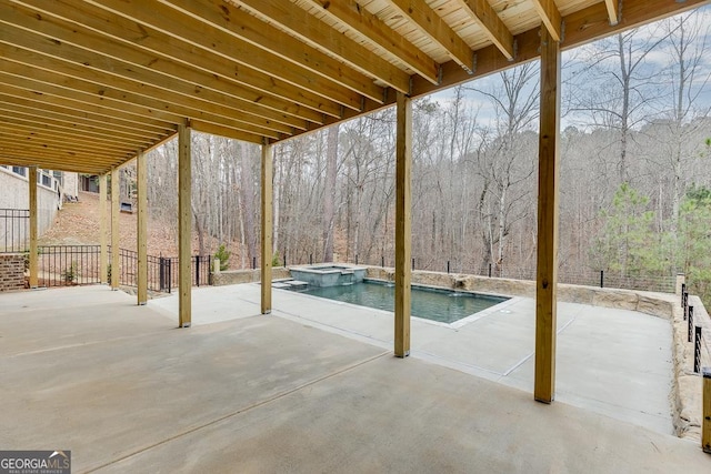 exterior space with a patio area and an in ground hot tub