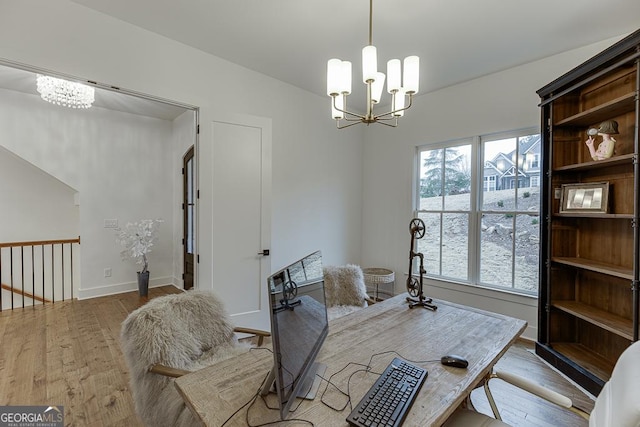 interior space featuring light wood-type flooring and a chandelier