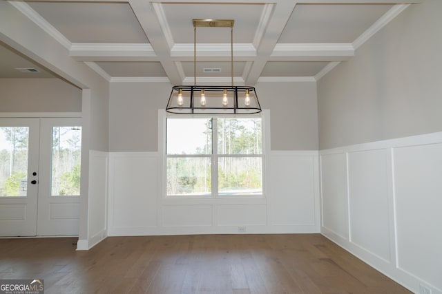 unfurnished dining area with coffered ceiling, hardwood / wood-style floors, beam ceiling, and french doors